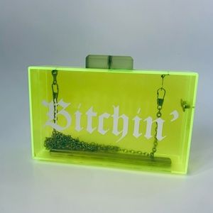 Neon green/yellow acrylic clutch with chain strap.